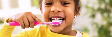 Little beautiful african girl brushing teeth, healthy concept
