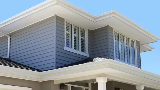 Two story gray sided house with white trim