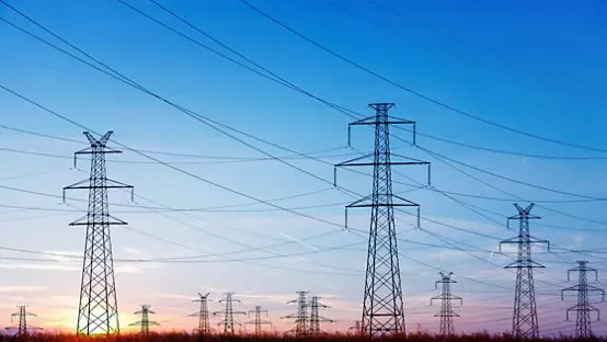 Landscape of power lines over a blue sky at sunrise or sunset