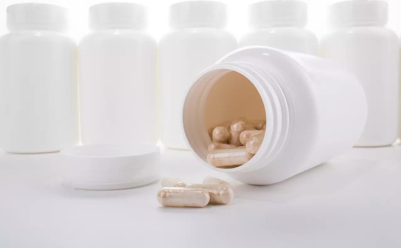 Generic pill bottles and capsules isolated on white background.