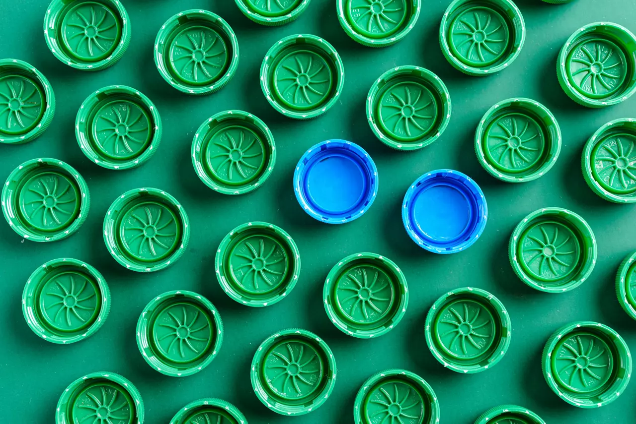 Plastic green caps from bottles and two blue caps
