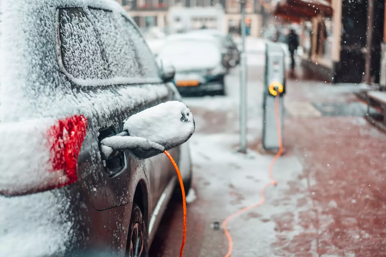 Electric car plug charging in the winter. Amsterdam, Netherlands