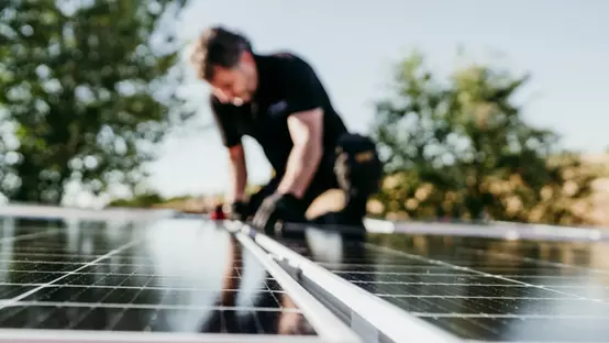 Mature Technician Man Assembling Solar Panels
