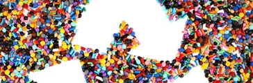 Recycle symbol amongst plastic granules