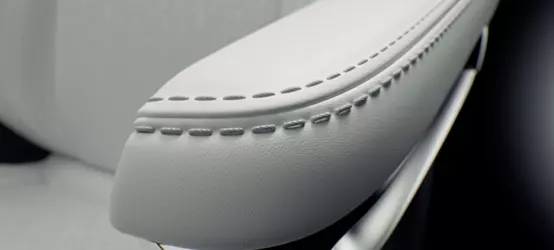 Automotive interior armrest with off-white silicone synthetic leather and stitching