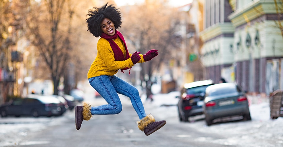 smiling black woman outside near a street