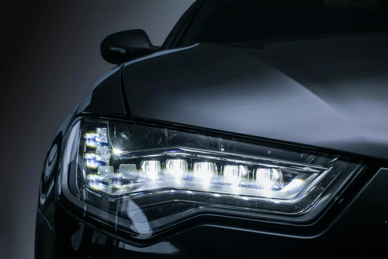 Headlight of modern prestigious black car close up