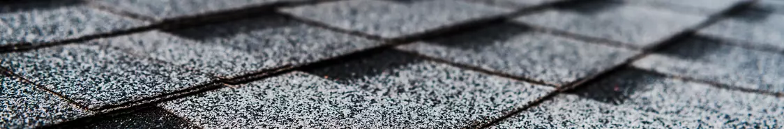 Grey shingles on a building rooftop 